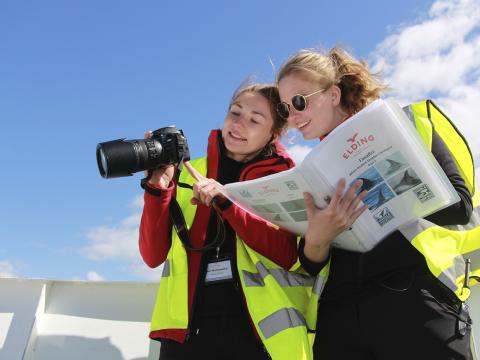 researchers looking at photo of a whale and comparing it with in folder