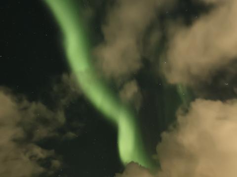 northern lights cruise through clouds