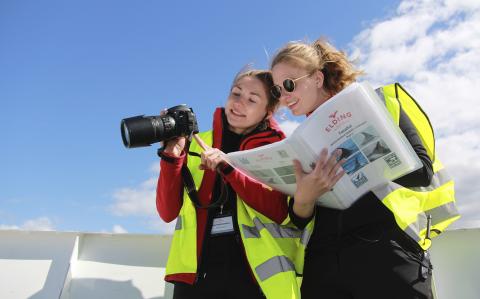 researchers looking at photo of a whale and comparing it with in folder