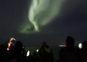 northern lights cruise, passengers look upon the auroras in the night sky