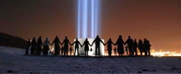 People form circle around the Imagine Peace Tower on Videy island