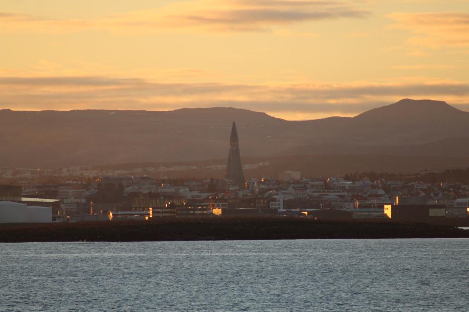 a view of reykjavik, hallgrímskirkja and surrounding mountains in the morning sunlight