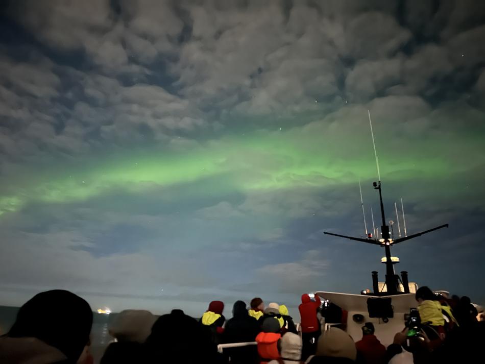 northern lights cruise with a boat full of people