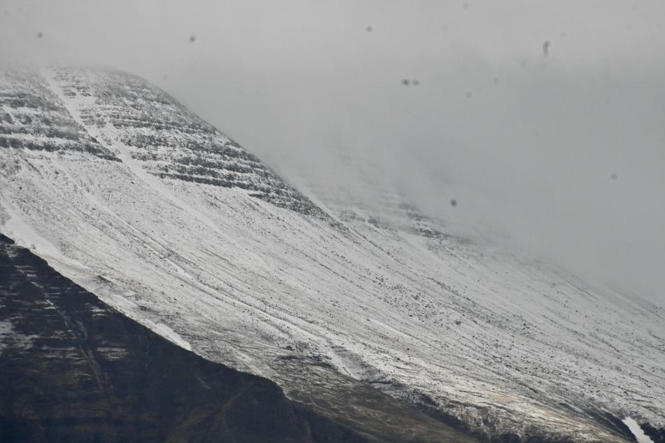 snowy mountain and moody weather