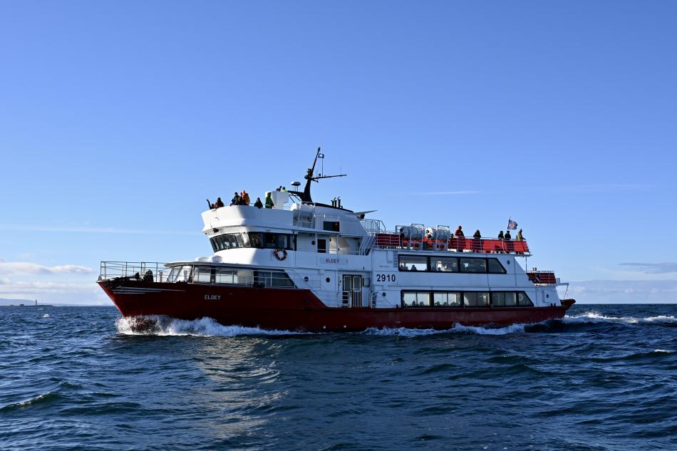Eldey whale watching boat at sea with passengers.