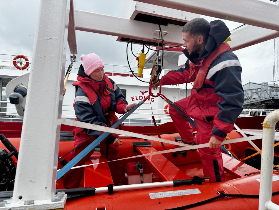 crew on MOB boat lowering it into the sea