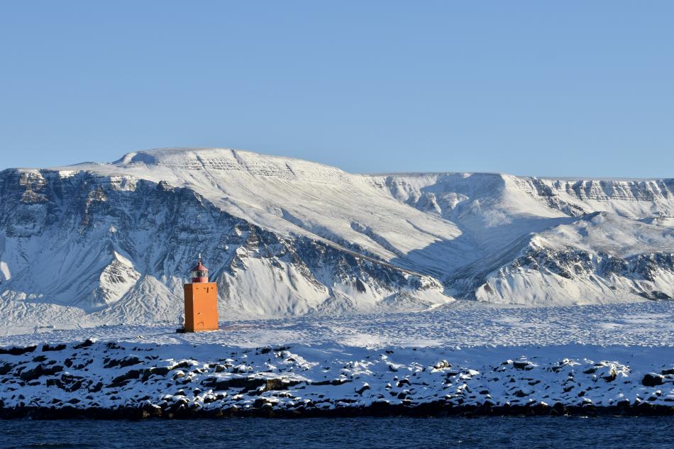 lighthouse with snowy mt. Esja in the background