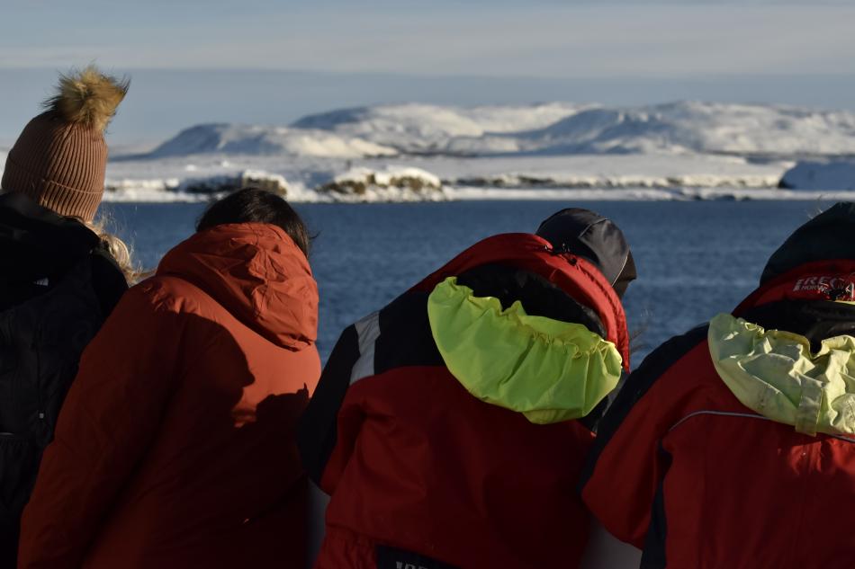 passengers look for whales in the winter landscape of Reykjavik