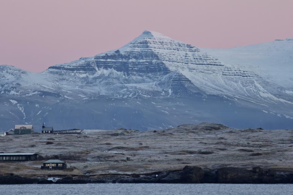 mountain lit up by pink sunrise