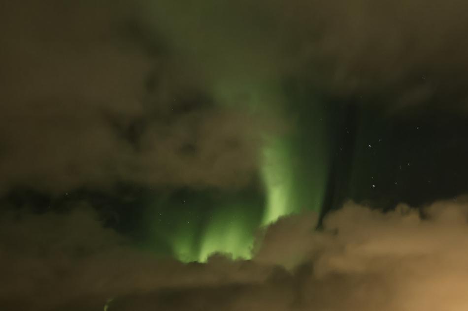 northern lights cruise through clouds