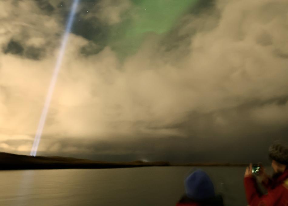 northern lights through gaps in the clouds