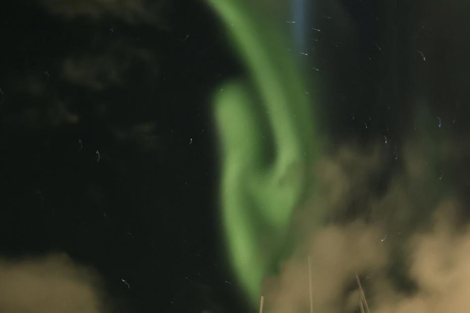 northern lights cruise through clouds