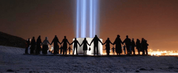 People form circle around the Imagine Peace Tower on Videy island