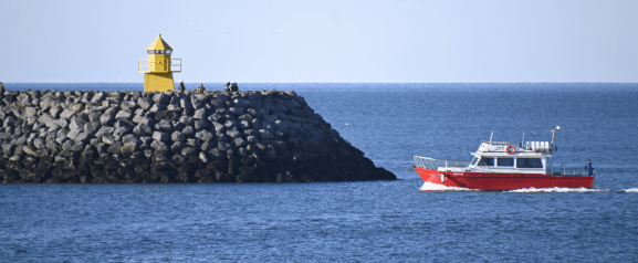 viðey ferry sails back to skarfabakki pier by lighthouse